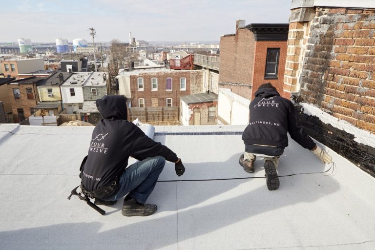 image of four twelve team working on a on flat roof