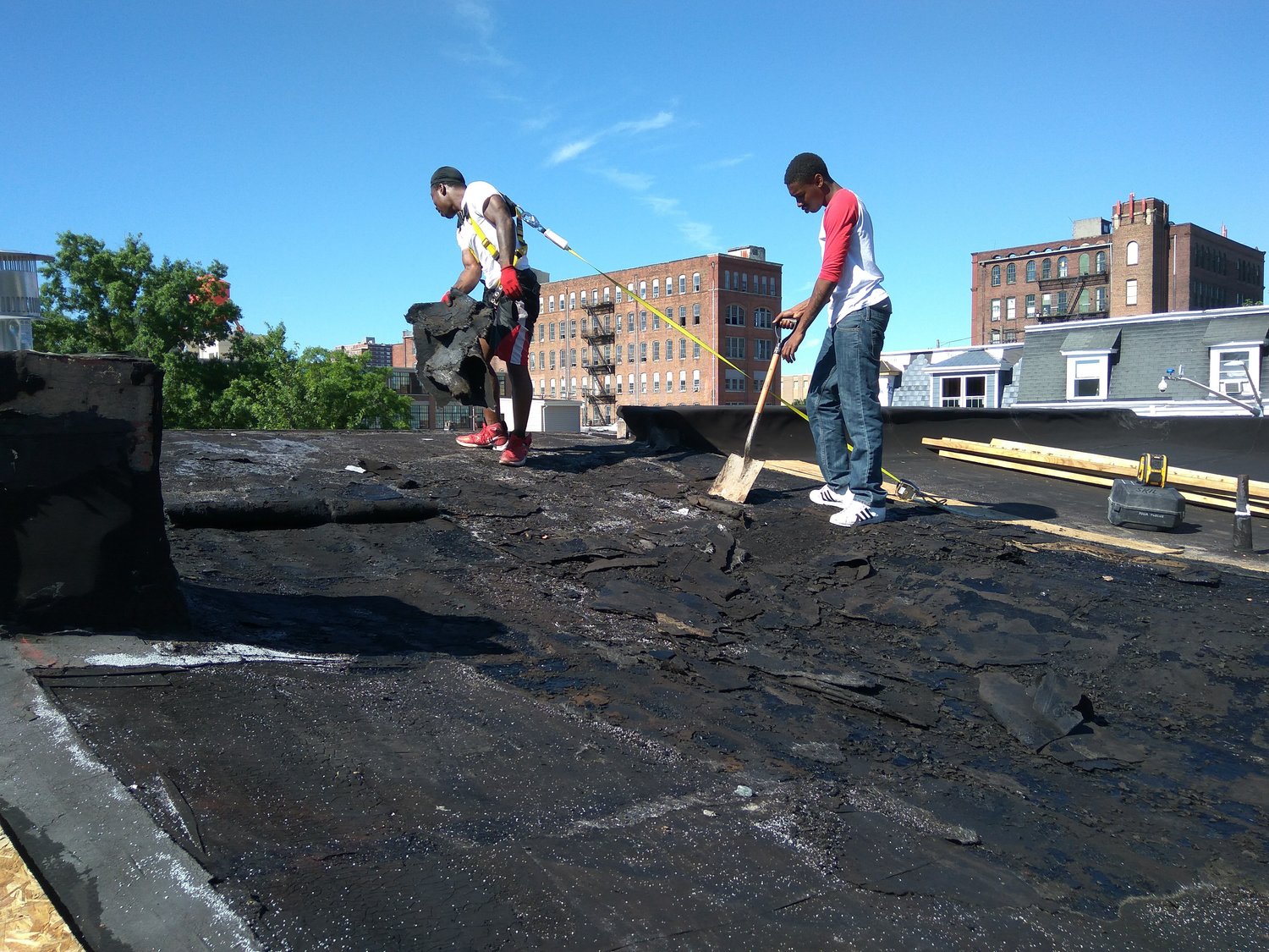 image of roofing workers cleaning roof