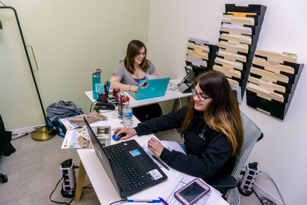 Two Four Twelve employees in the office