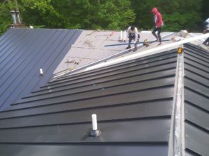 Four Twelve roofers install a standing seam metal roof.