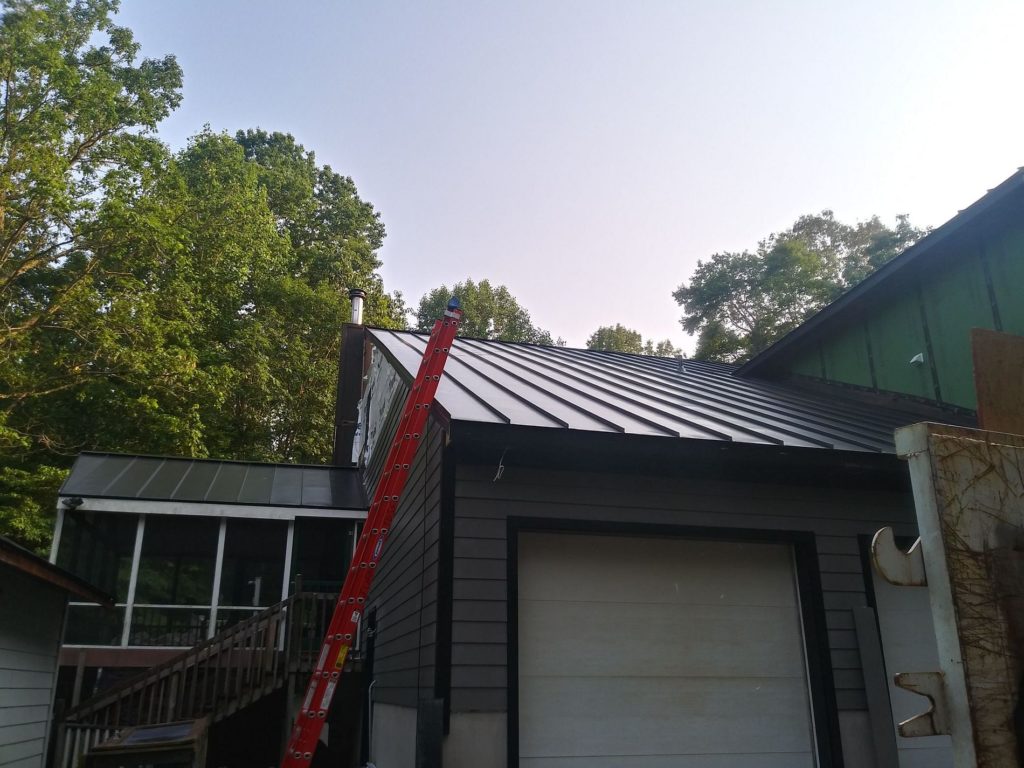 Exterior of home showing new standing seam metal roof.