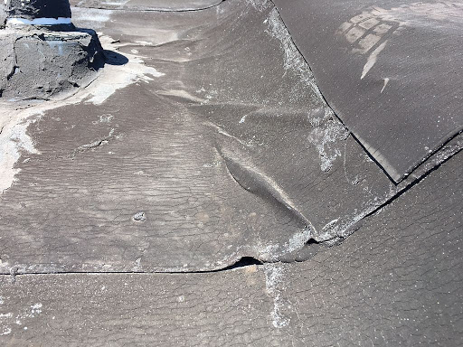 A damaged roof being repaired by FT